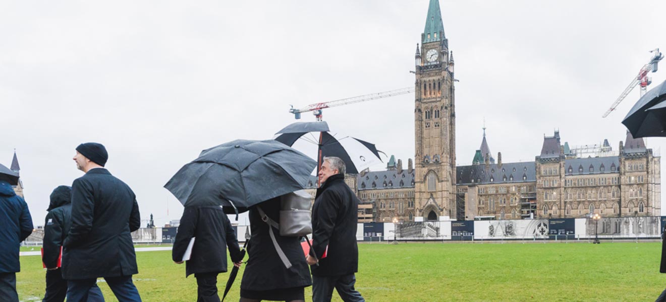 People walking past Parliament Hill