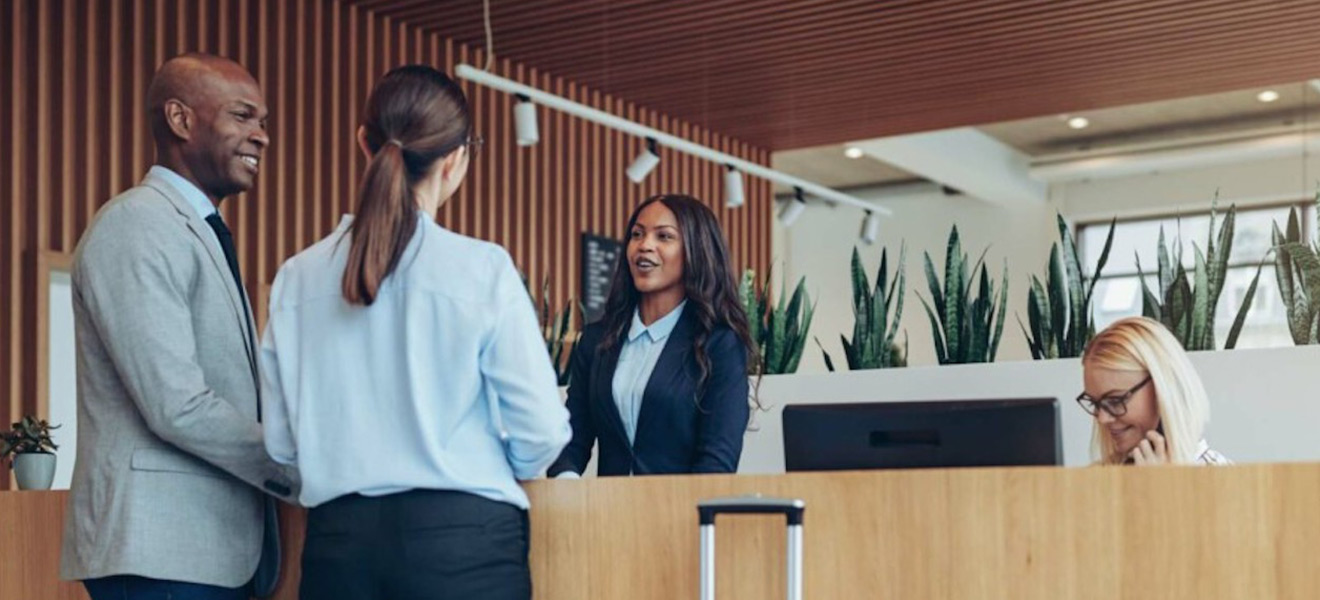 Two people at a hotel front desk