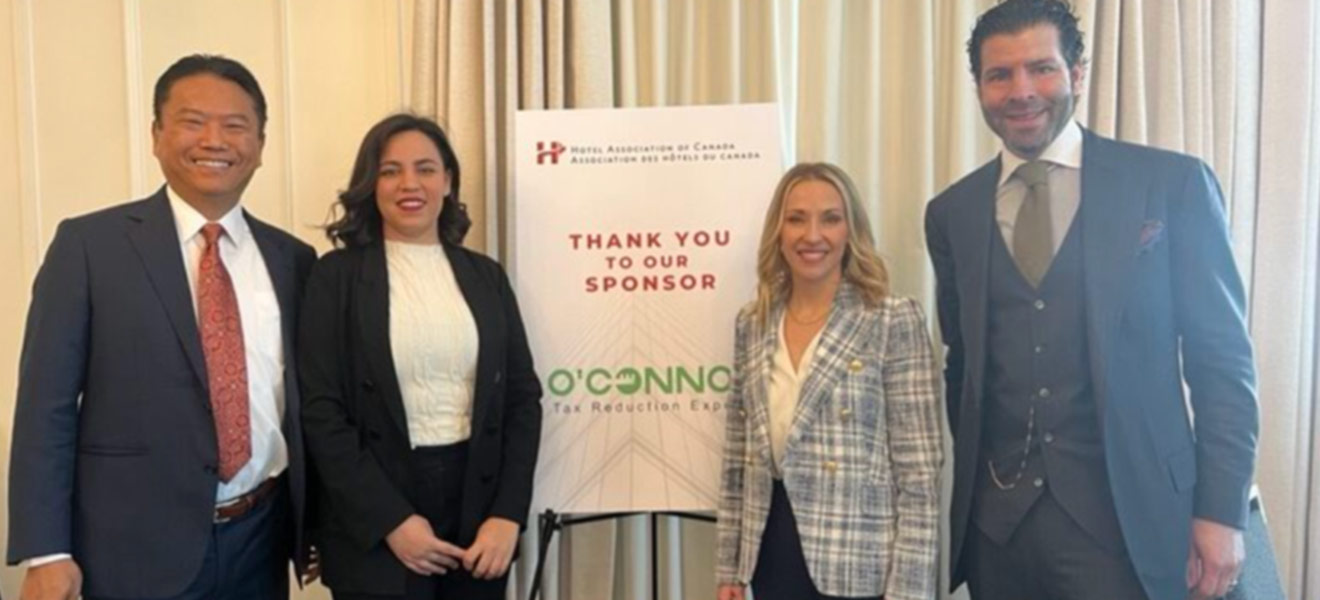 Group standing in front of a Thank You sign
